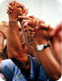 Kairos Inside Graduate prisoners raising clasped hands in celebration
